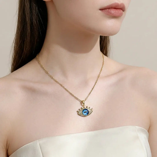 Necklace with a blue eye pendant worn by a model against a neutral background