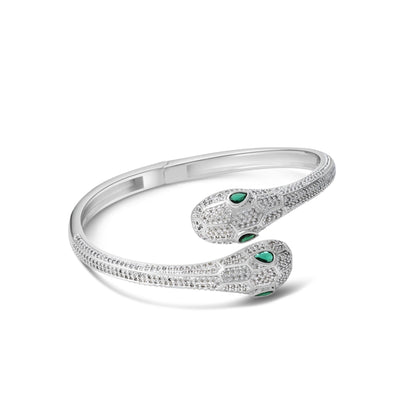 Silver bracelet with green gemstones on a white background
