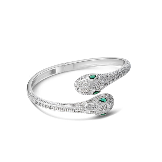 Silver bracelet with green gemstones on a white background