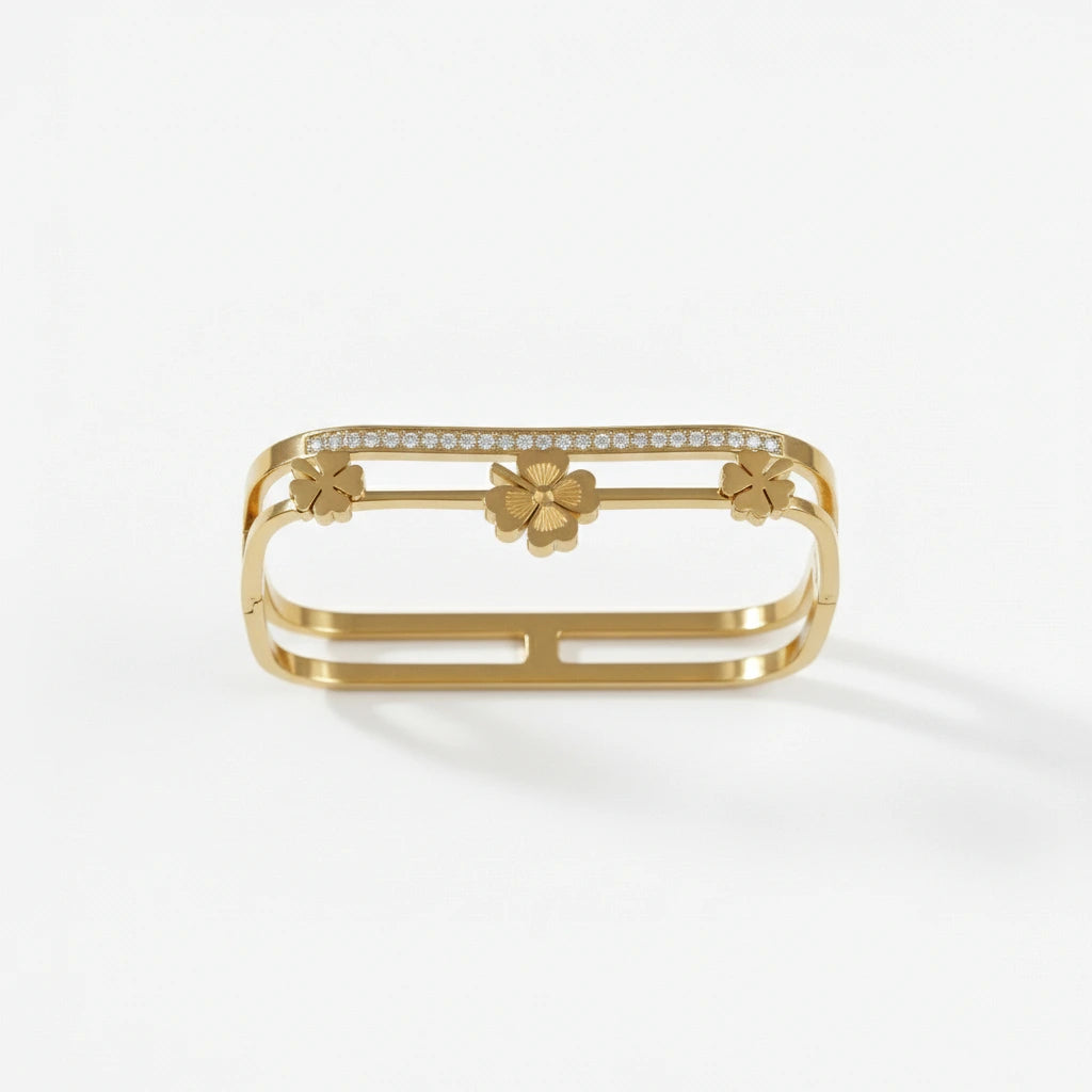 Gold bracelet with floral designs on a white background