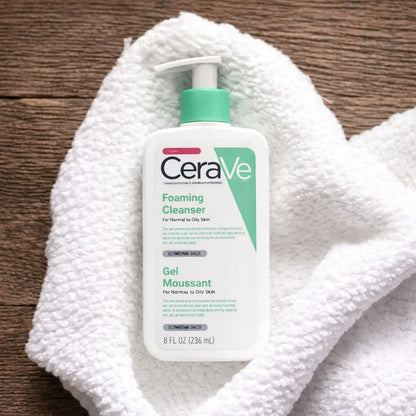 CeraVe foaming cleanser bottle on a white towel with a wooden background