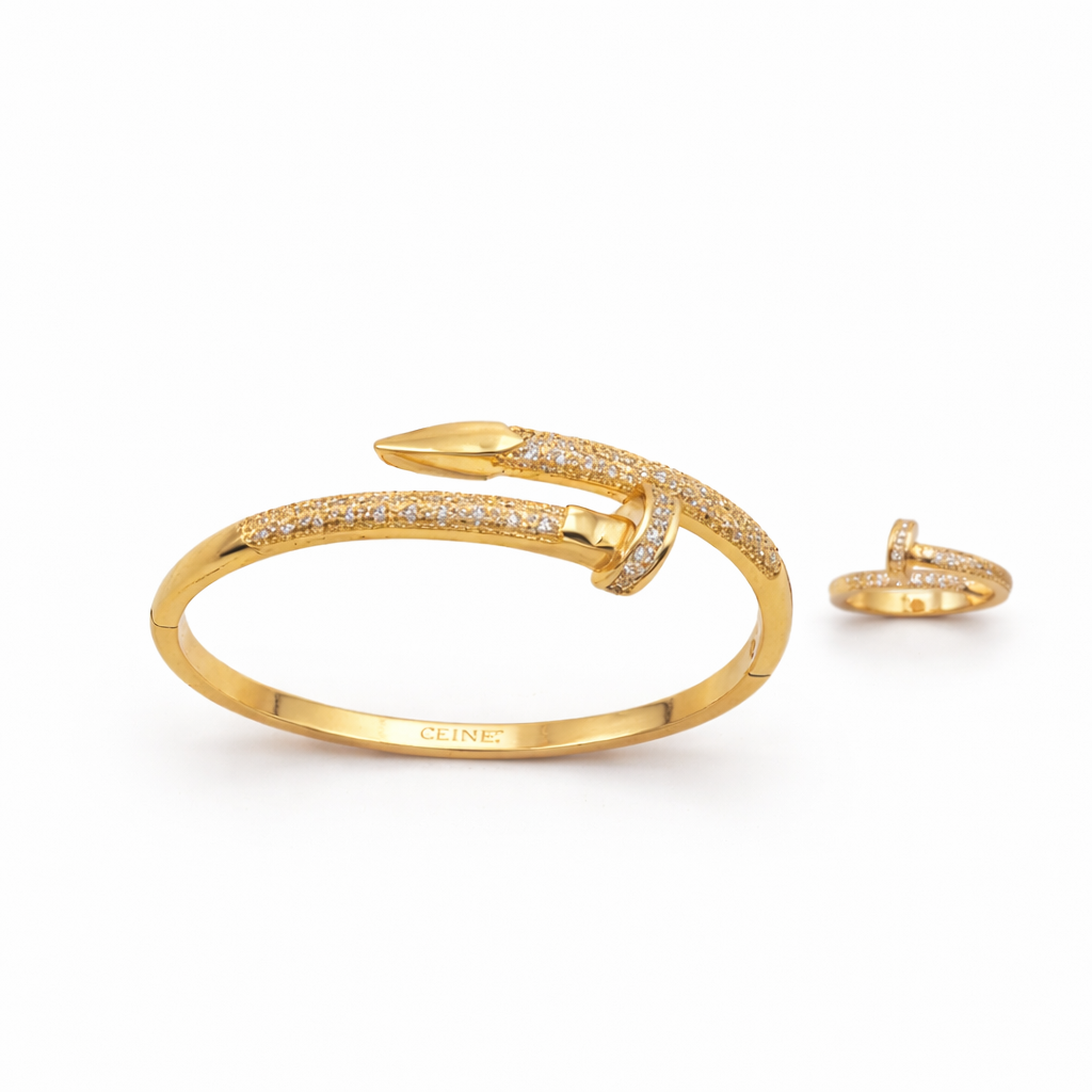Gold bracelet and ring set on a white background