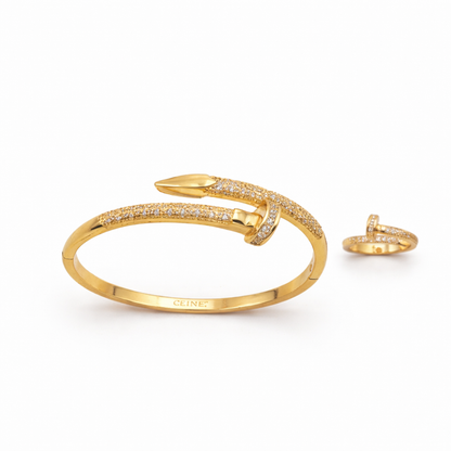 Gold bracelet and ring set on a white background