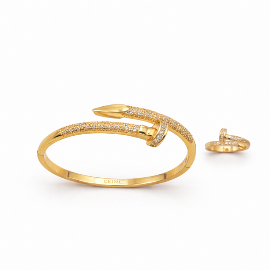 Gold bracelet and ring set on a white background
