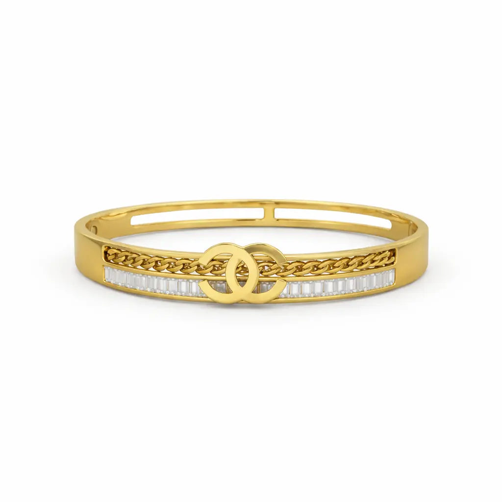 Gold bracelet with chain design and clear stones on a white background