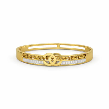 Gold bracelet with chain design and clear stones on a white background