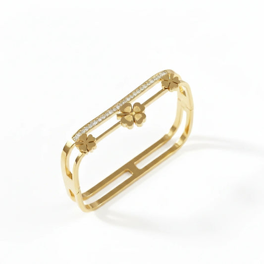 Gold bracelet with floral designs on a white background