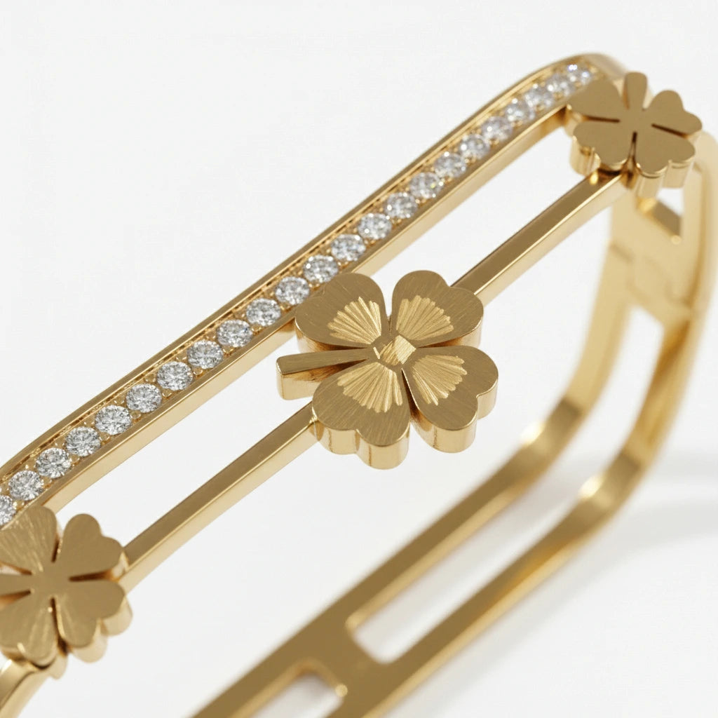 Gold bracelet with clover designs and clear stones on a white background