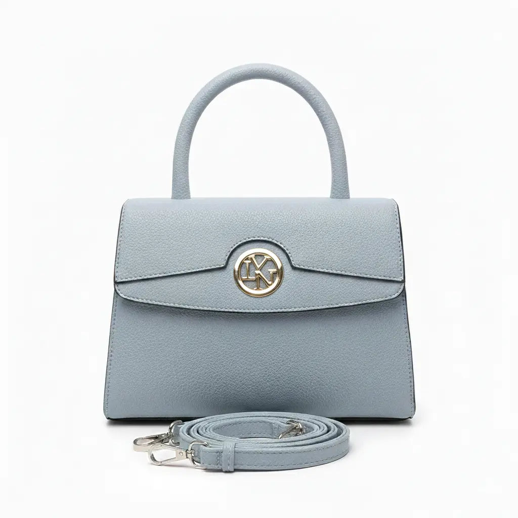 Light blue handbag with a gold emblem on a white background