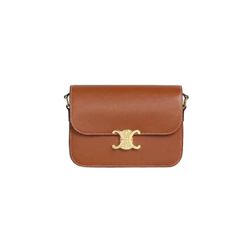 Brown leather handbag with gold clasp on a white background