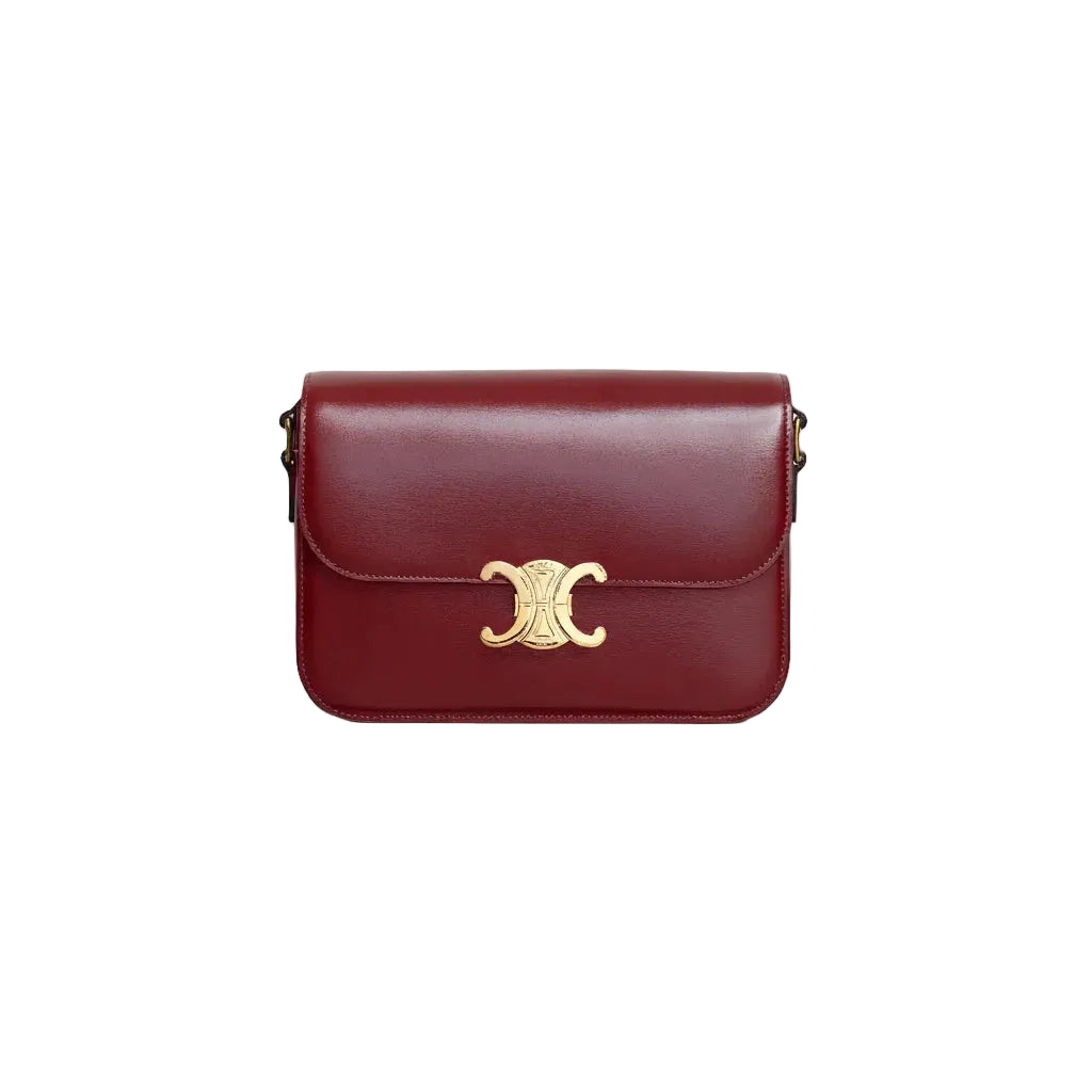Red handbag with a gold clasp on a light gray background