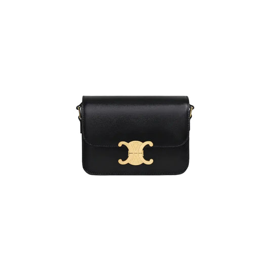 Black handbag with a gold clasp on a light gray background