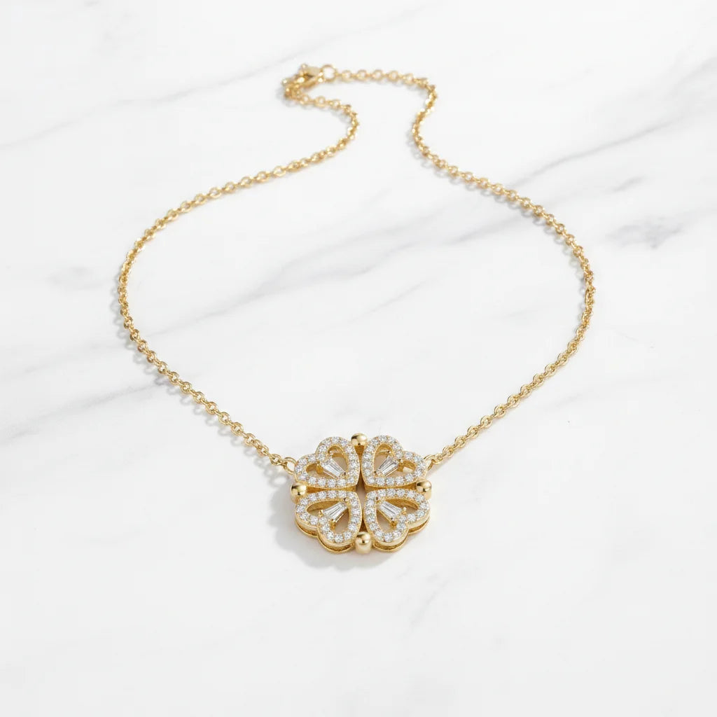 Gold necklace with a floral pendant on a white background