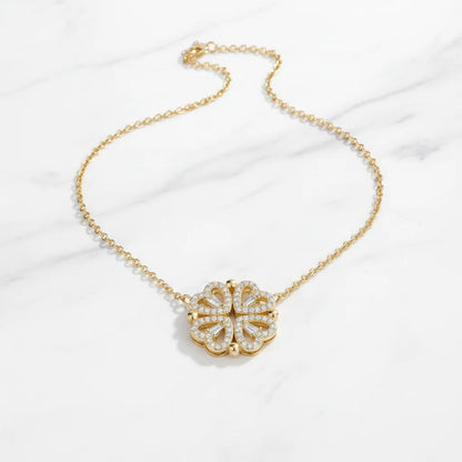 Gold necklace with a floral pendant on a white background