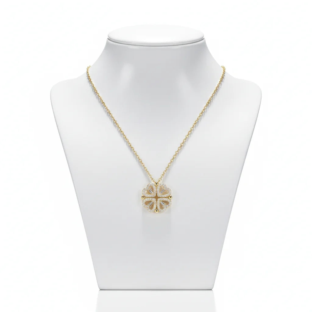 Gold necklace with a floral pendant on a mannequin bust against a white background