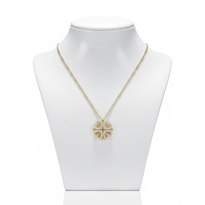 Gold necklace with a floral pendant on a mannequin bust against a white background