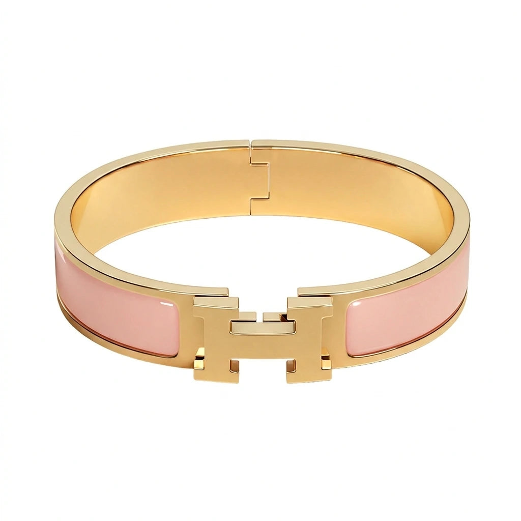 Gold bracelet with beige accents on a white background pink