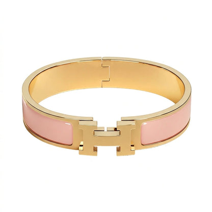 Gold bracelet with beige accents on a white background pink
