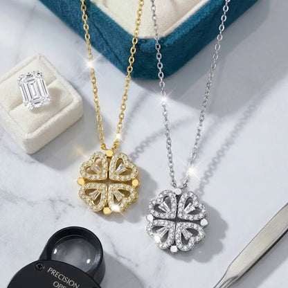 Two diamond pendants on gold and silver chains with a ring and loupe in the background.