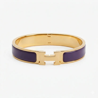 Gold bracelet with beige accents on a white background purple