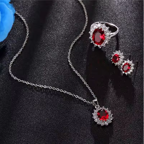 Jewelry set with red gemstones on a black background