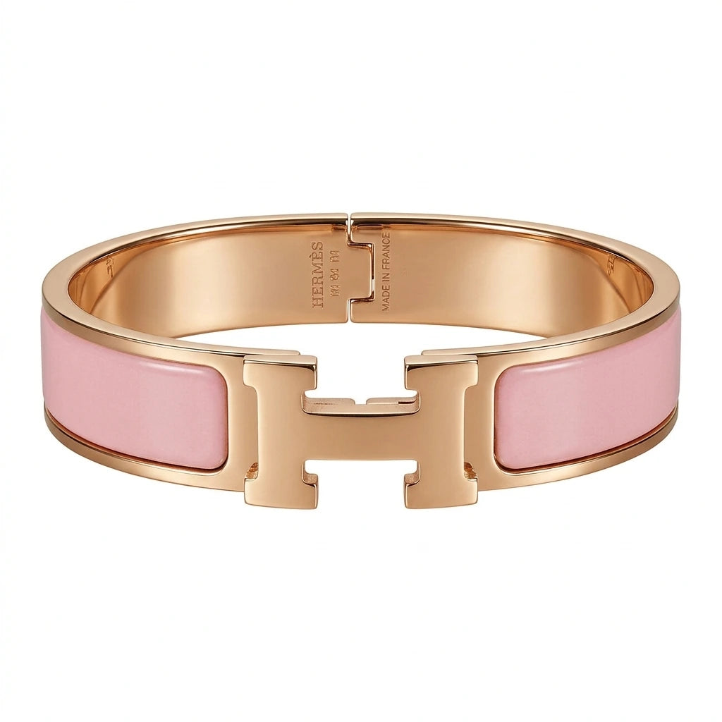 Rose gold bracelet with pink enamel on a white background