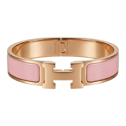 Rose gold bracelet with pink enamel on a white background