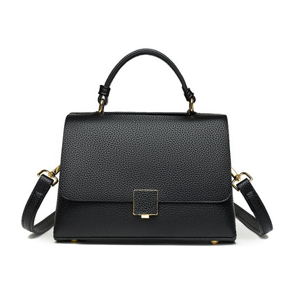 Black handbag with gold accents on a white background