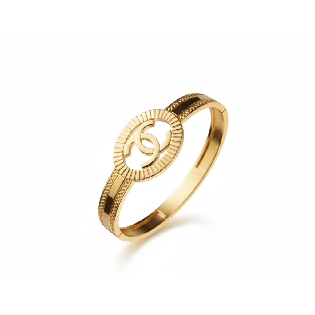 Gold ring with a circular design on a white background