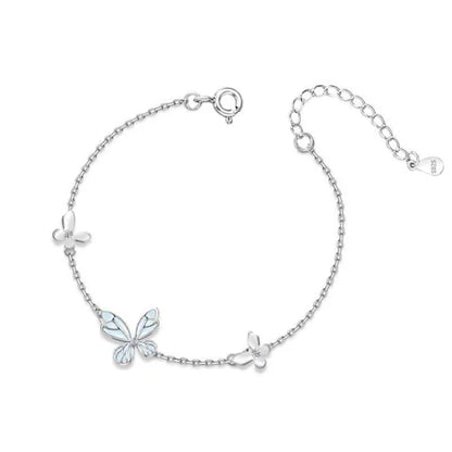 Silver bracelet with butterfly charms on a white background