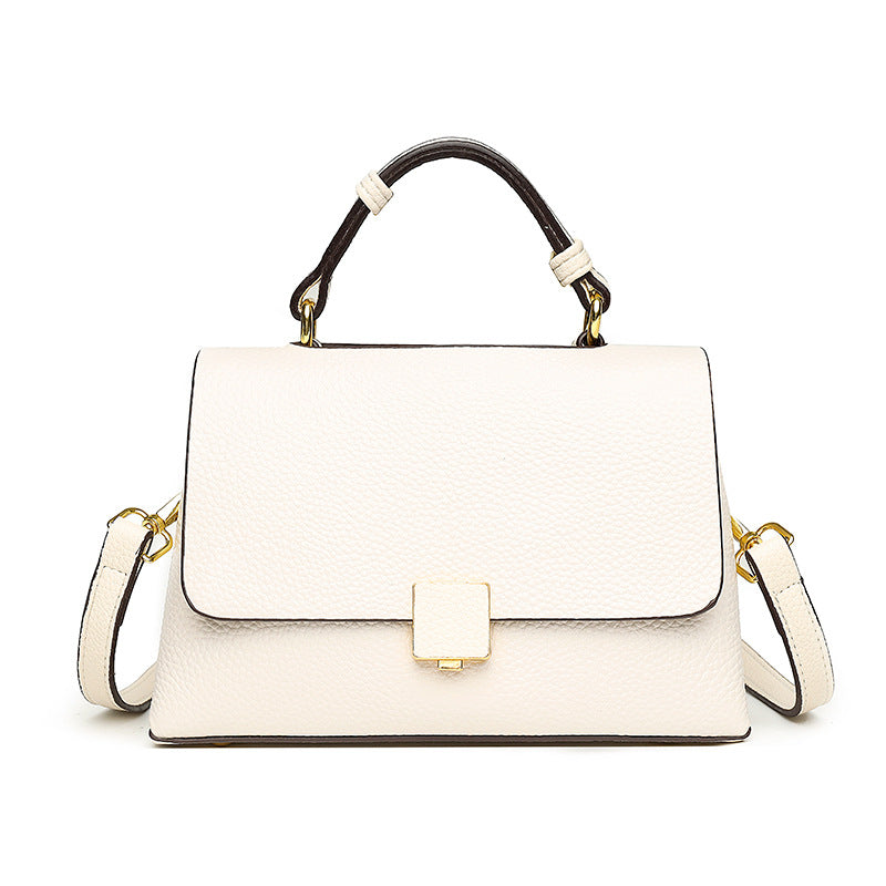 White handbag with black accents on a white background
