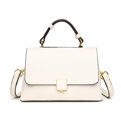 White handbag with black accents on a white background