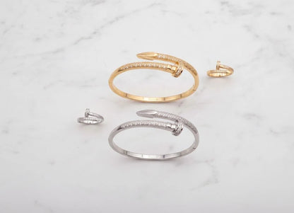 Gold and silver open bracelets on a marble surface