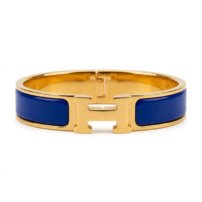 Gold bracelet with beige accents on a white background royal blue